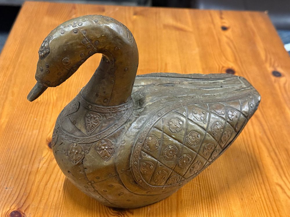 Lot 49: A decorative riveted brass folk art duck figurine