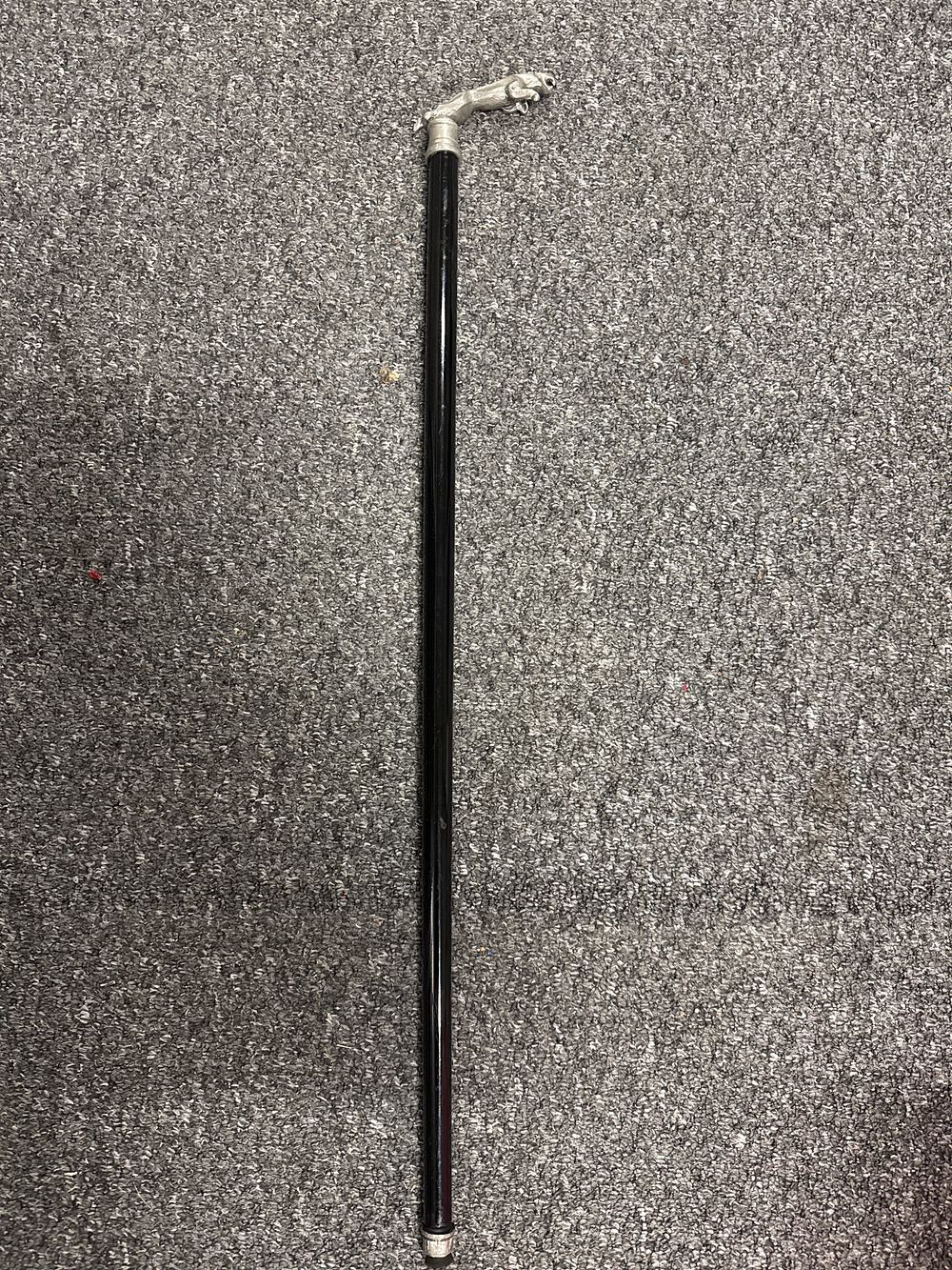 Lot 136: A decorative ebonised walking cane with leaping Jaguar handle