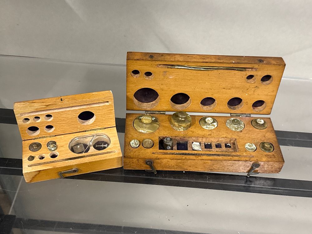 Lot 113: Two sets of vintage brass apothecary weights in wooden cases