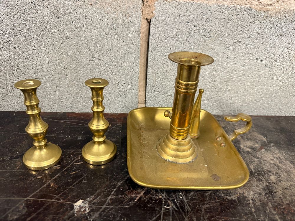 Lot 57: A trio of antique style brass candlesticks including a chamberstick