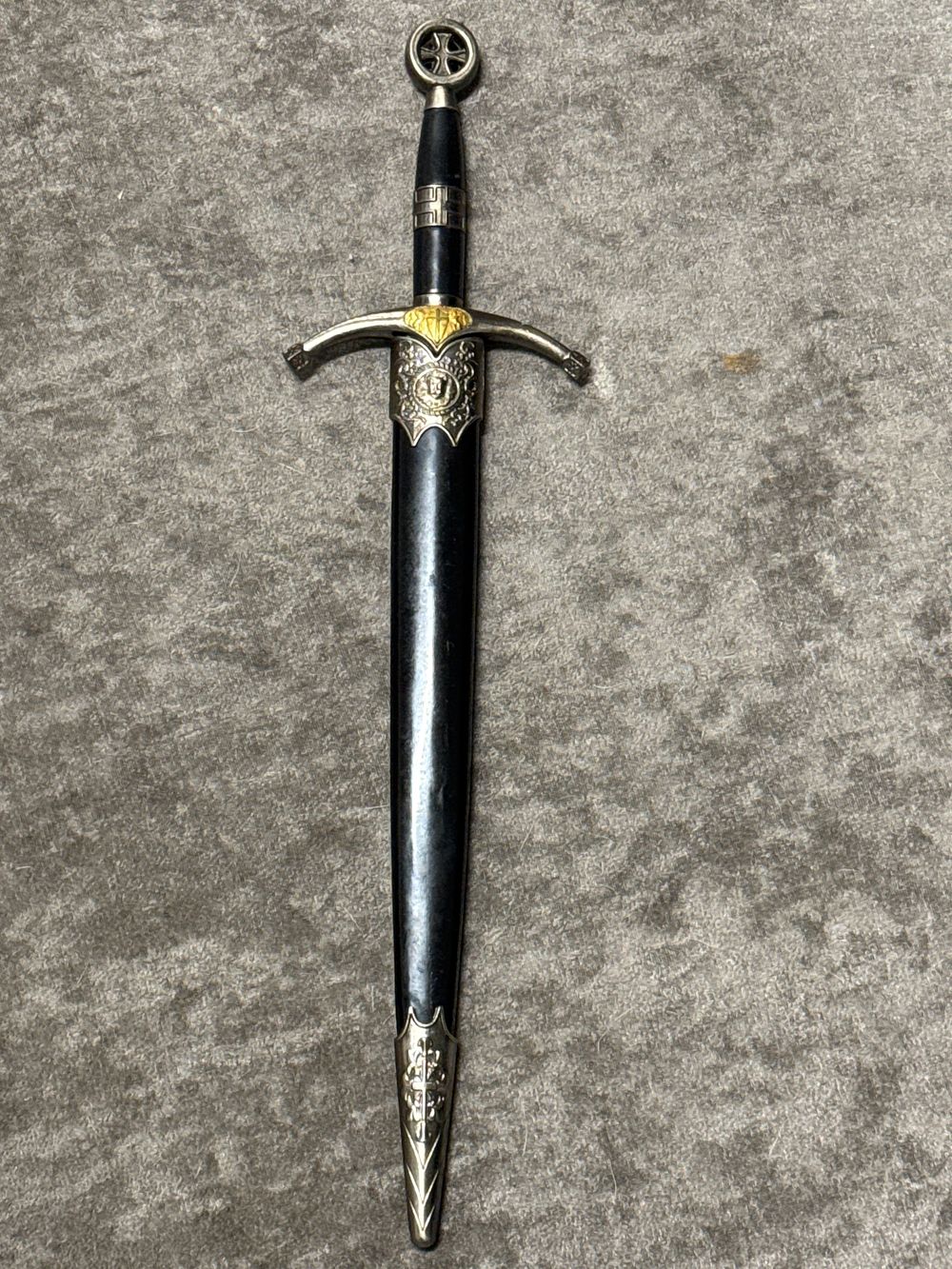 Lot 111: A decorative medieval style dagger with matching black scabbard