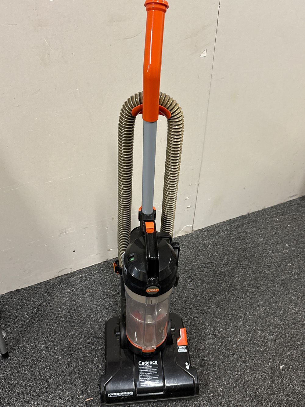 Lot 141: A Vax Cadence bagless upright vacuum cleaner in orange and black