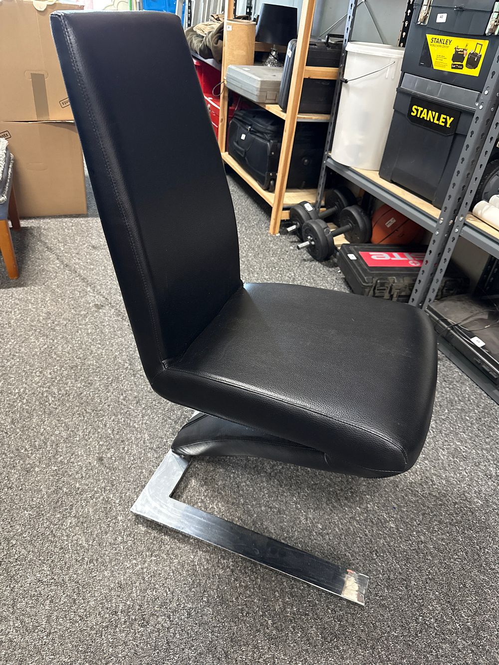 Lot 116: Modern cantilever chair with black upholstery and chrome frame