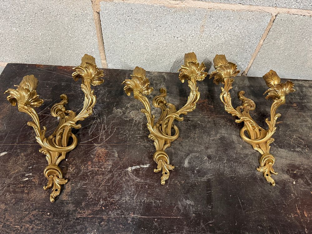 Lot 50: A trio of Rococo style cast brass two-light wall sconces