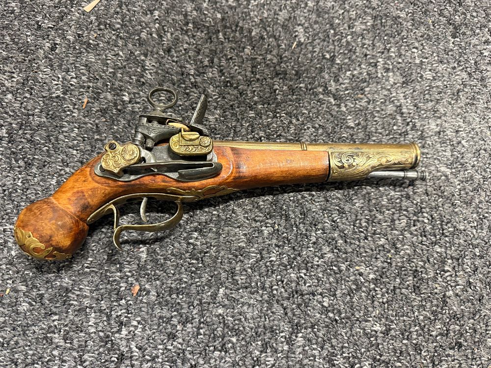 Lot 75: Decorative replica flintlock pistol with ornate brass-coloured scrollwork