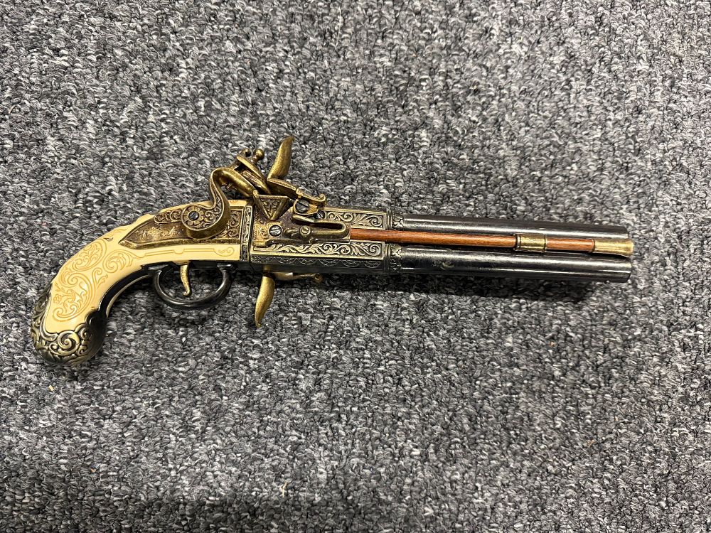 Lot 76: A decorative double-barrel flintlock pistol replica with cream grips