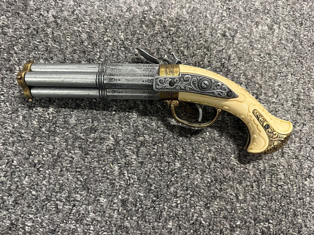 Lot 77: A decorative four-barrel flintlock pistol replica with faux-ivory grip