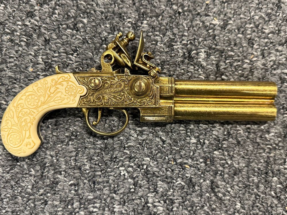 Lot 79: A decorative double-barrelled flintlock pistol replica with ornate grips