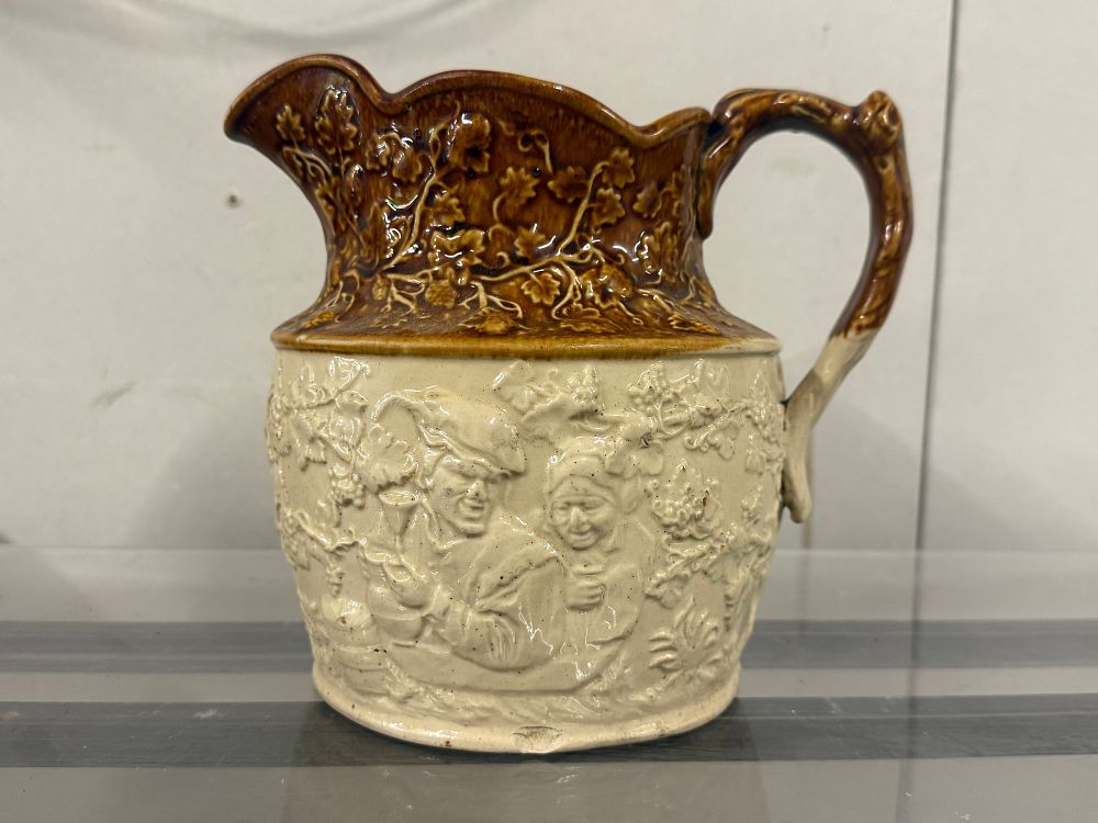 Lot 44: A two-tone salt-glazed stoneware harvest jug with tavern scenes