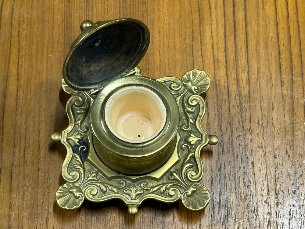 Lot 90: A Victorian style cast brass desk inkwell with ceramic liner