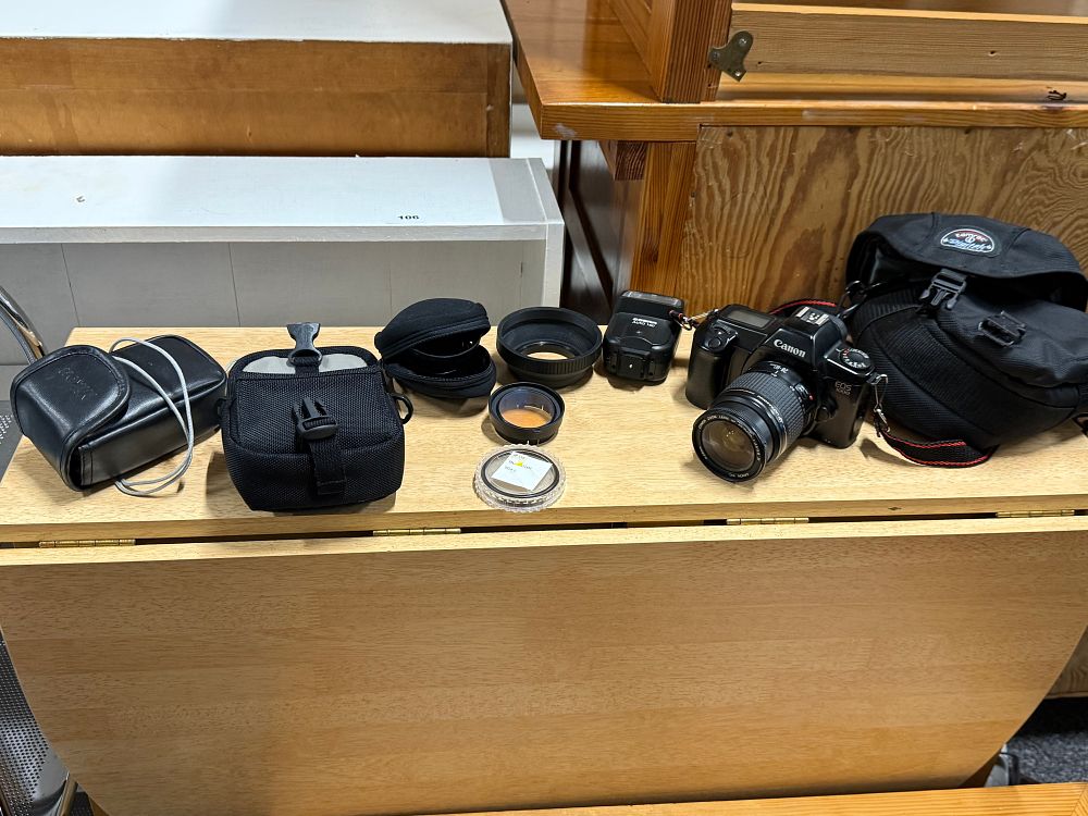 Lot 59: A Canon EOS 1000 SLR camera with lens and accessories