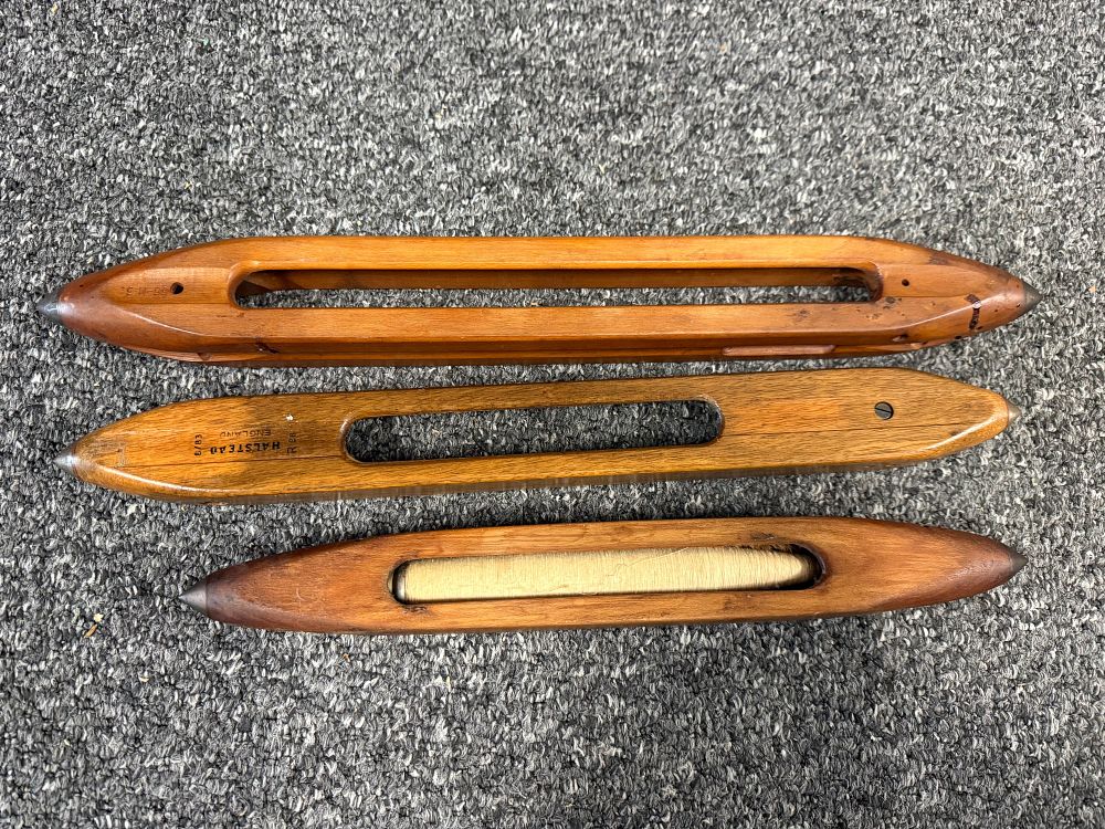 Lot 93: A trio of vintage wooden weaving shuttles from Halstead England
