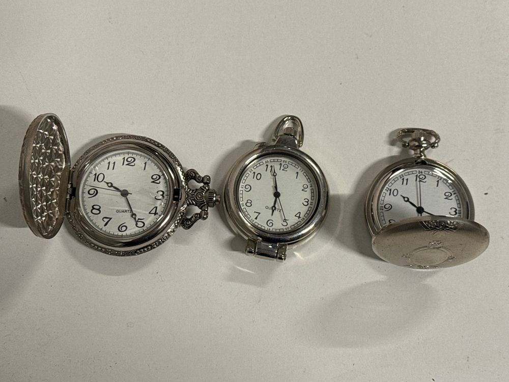Lot 105: Three silver-tone quartz pocket watches with locomotive and engine-turned cases