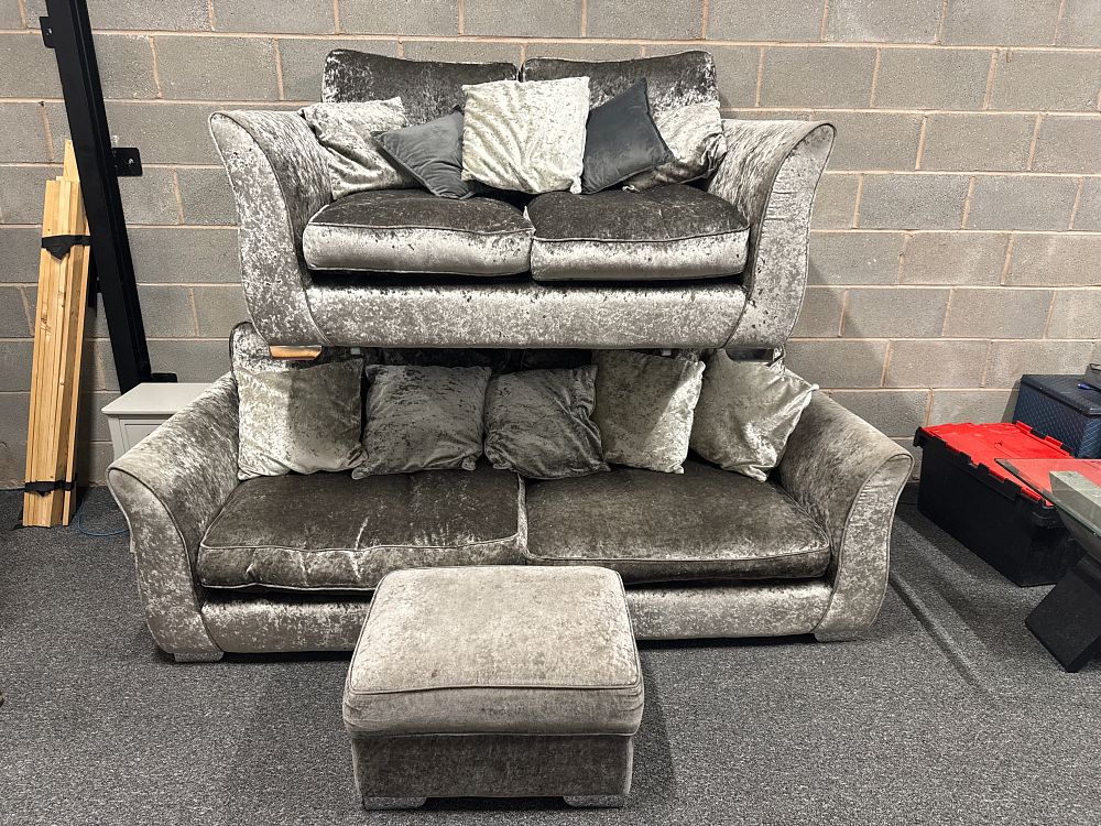 Lot 142: A contemporary silver-grey crushed velvet sofa suite and footstool