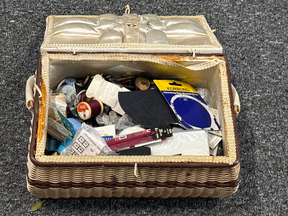 Lot 129: A vintage two-tone woven sewing basket with Sylko thread and assorted notions