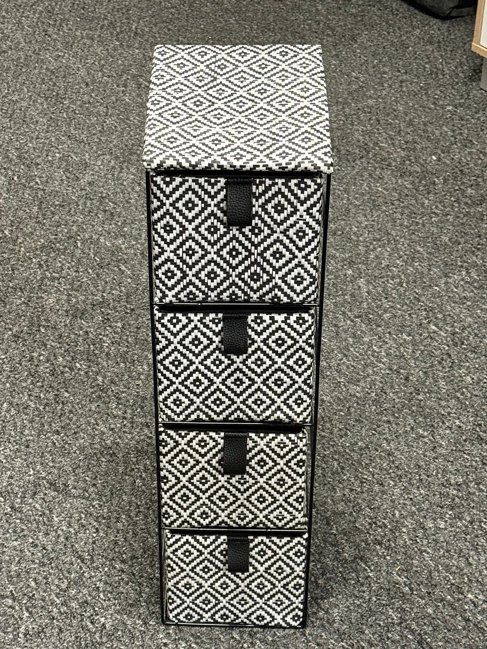 Lot 131: A contemporary four-drawer storage unit with geometric diamond pattern
