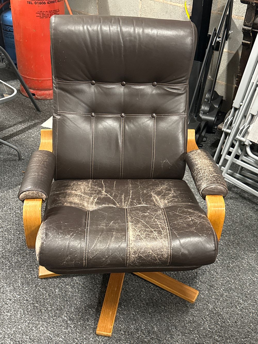Lot 150: A mid-century modern brown leather and bentwood swivel armchair