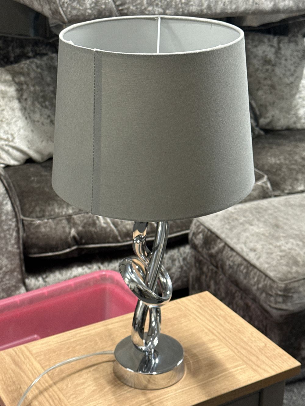 Lot 154: A contemporary polished chrome table lamp with knot motif