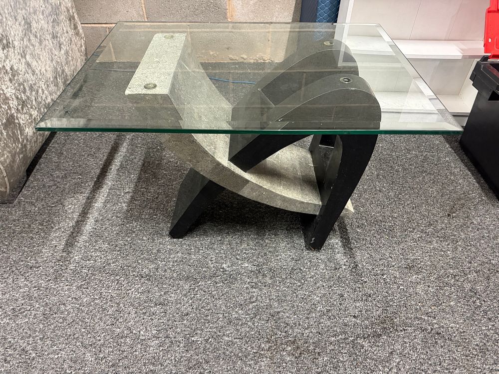 Lot 156: A modern glass coffee table with a sculptural interlocking base