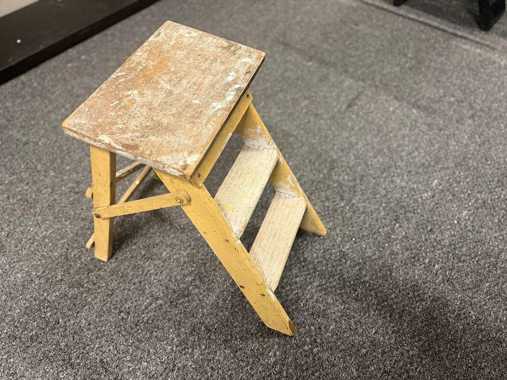 Lot 166: A vintage wooden three-tier folding step stool in yellow