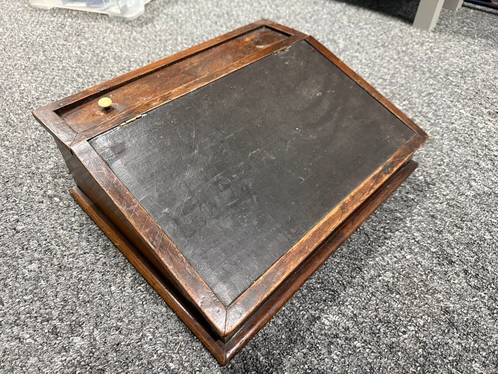 Lot 184: An antique mahogany lap desk with inset writing surface