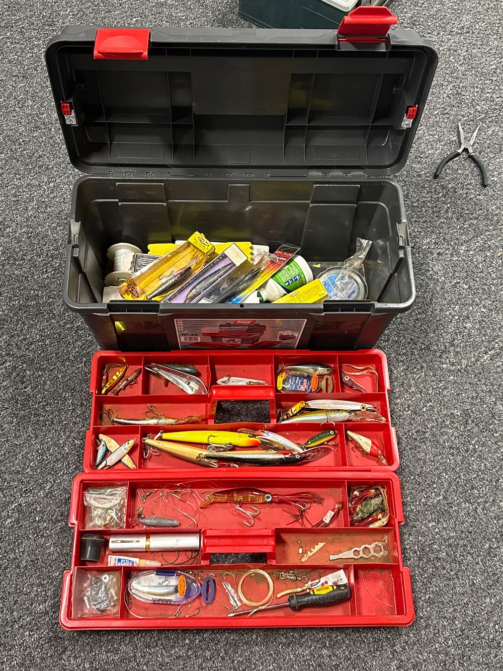 Lot 240: Assortment of fishing lures and equipment in a Tayg box