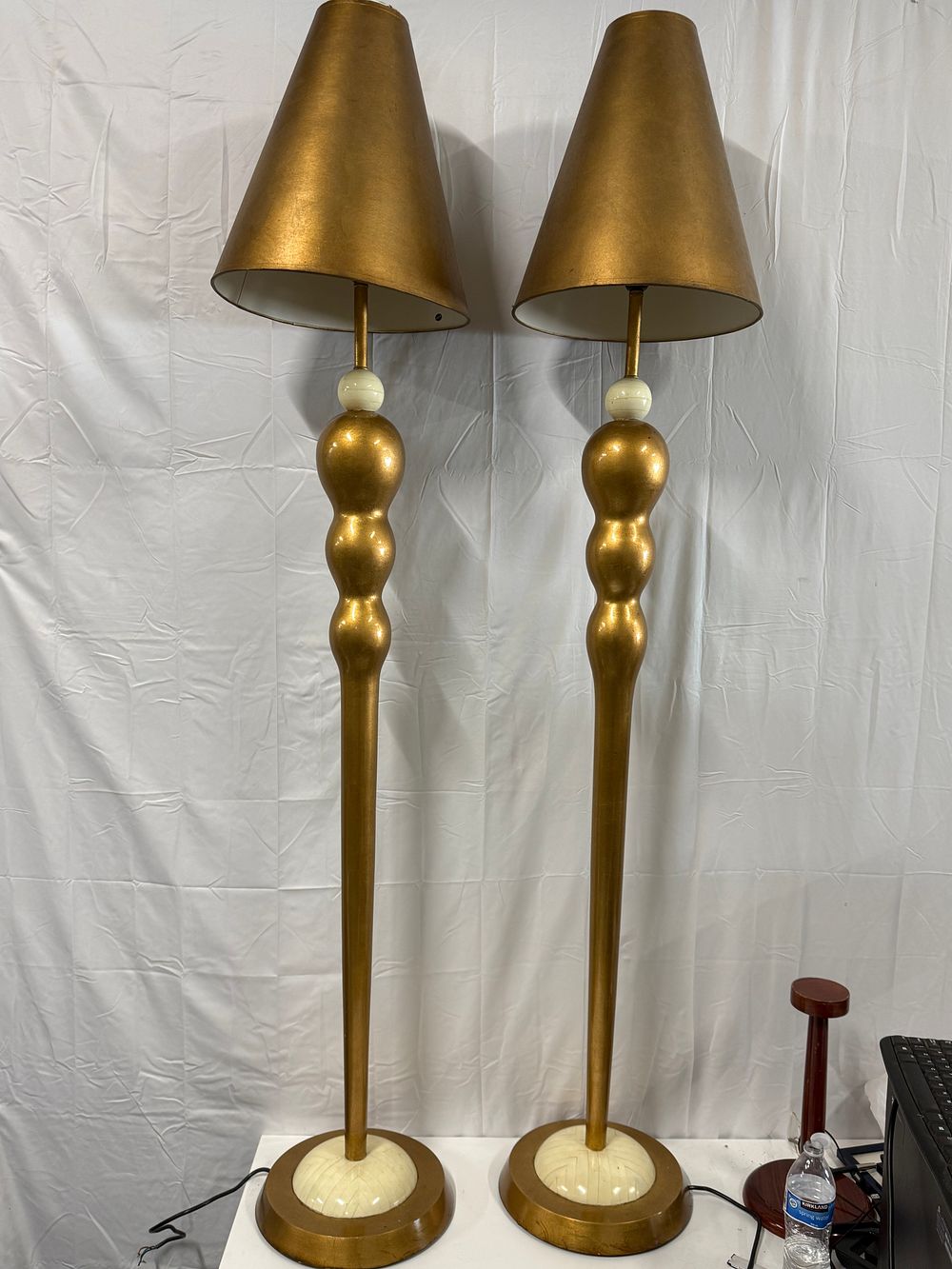 Lot 275: A pair of vintage Leeazanne style tall gold-toned Standard lamps with triple orb stems