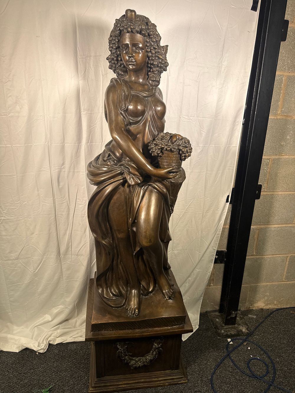 Lot 279: 5.5feet Tall A large bronze-patinated sculpture of Autumn on a carved pedestal, 77kg Approx The starting price is the scrap value by weight !