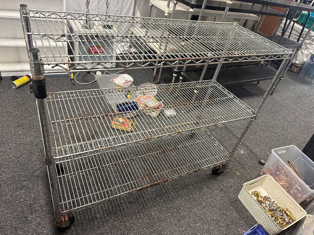 Lot 284: A mobile three-tier chrome-plated steel industrial wire shelving unit. 41” high 48” long and 18” deep