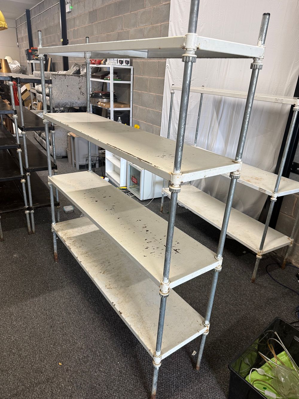 Lot 286: An industrial modular four-tier pipe and sheet metal shelving unit