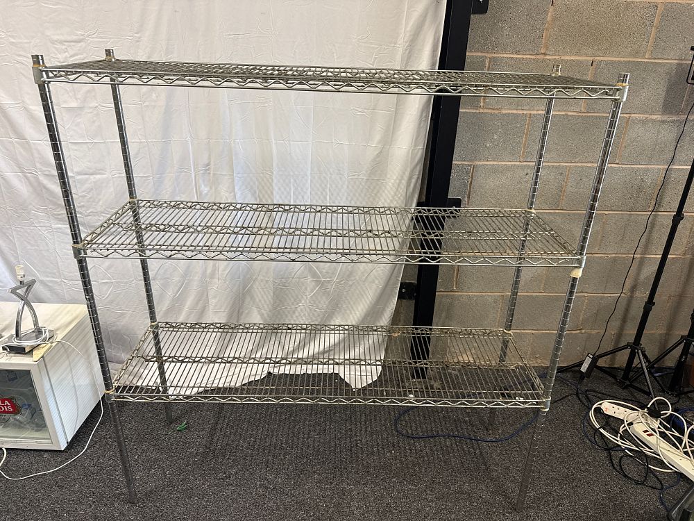 Lot 291: A three-tier chrome-finished metal wire shelving unit