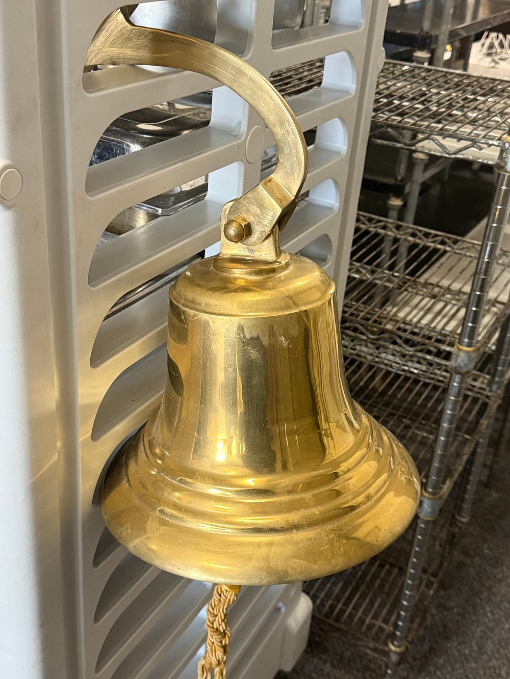 Lot 3a: A substantial wall mounted brass ship's bell with mounting bracket. Weighs Approx 10 Kg