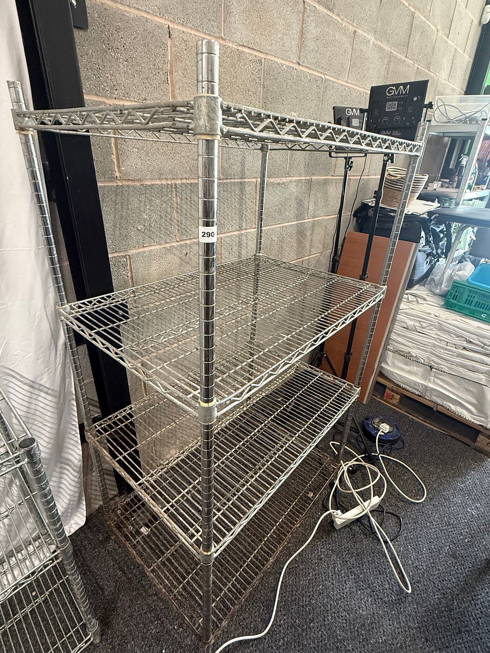 Lot 290: A four-tier industrial wire storage shelving unit