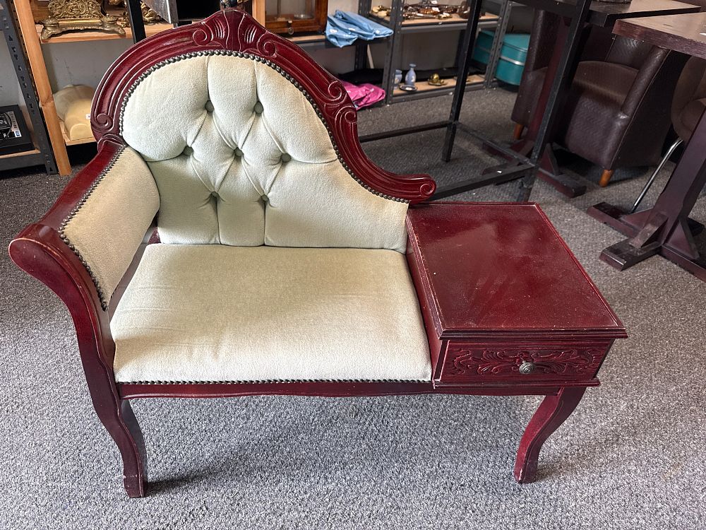Lot 305: A dark wood telephone seat with button tufted green upholstery