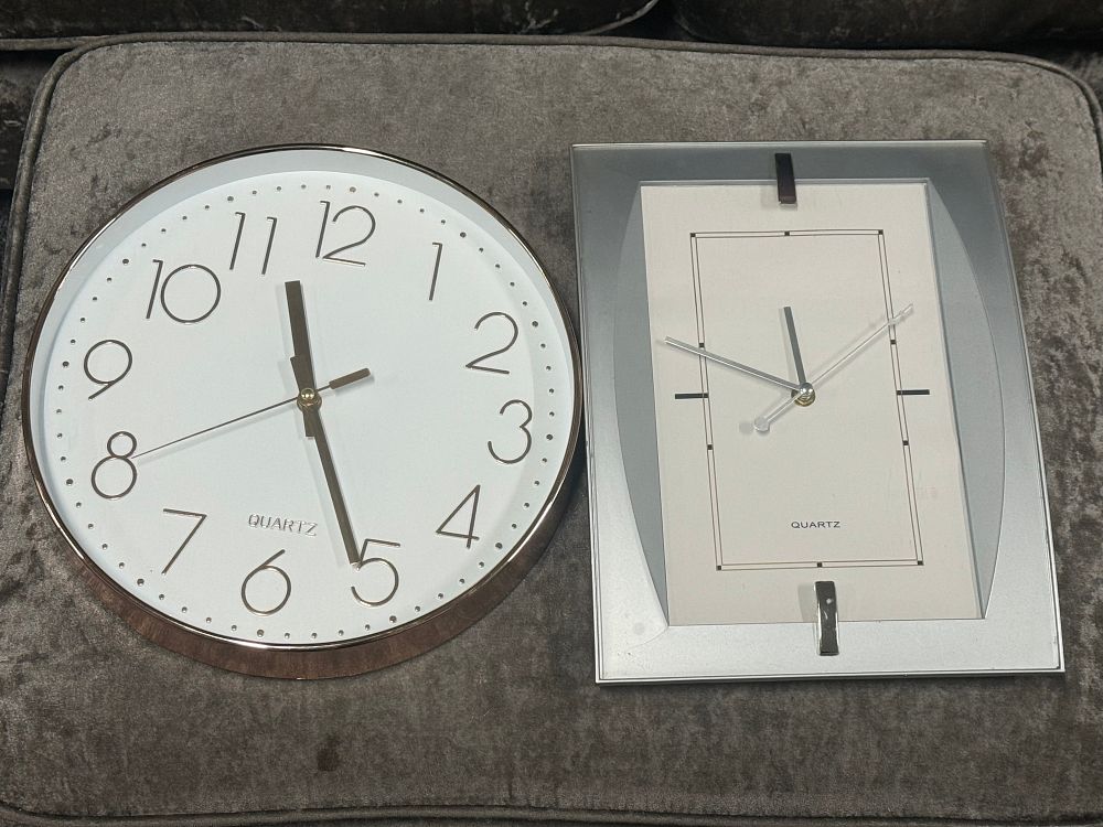 Lot 62: Two modern quartz battery operated wall clocks in metallic finishes