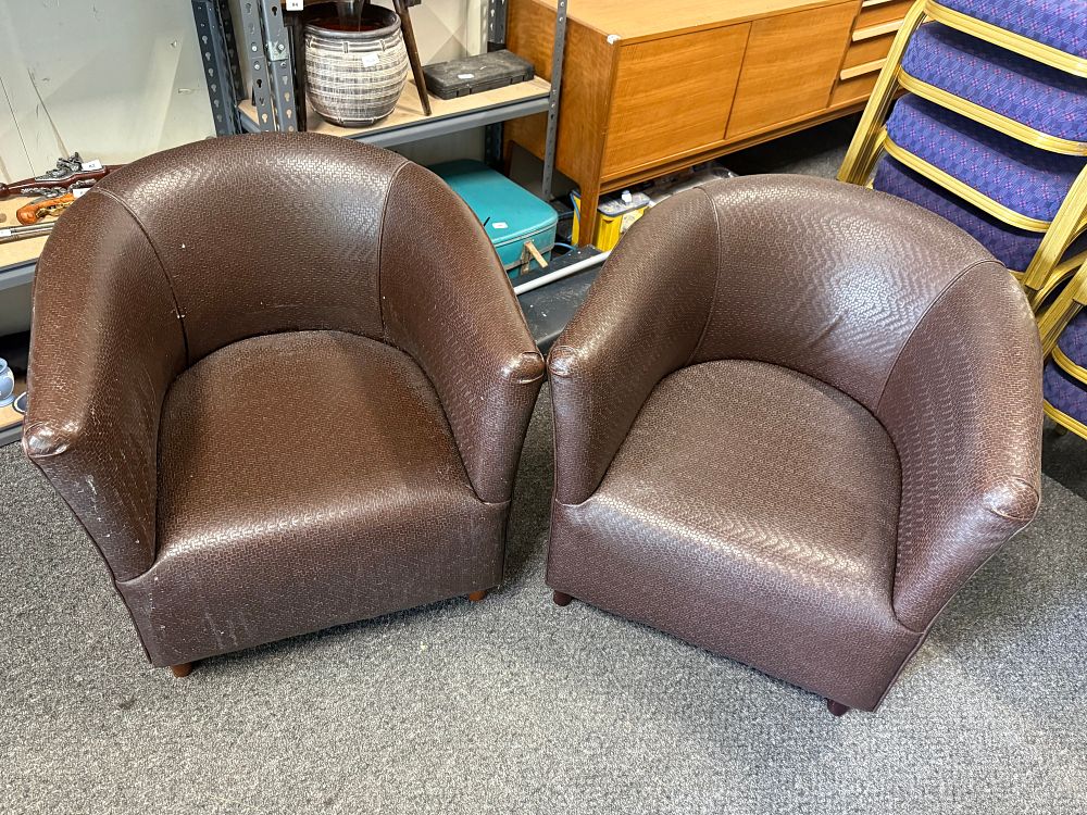 Lot 104: A pair of dark brown textured tub-style armchairs