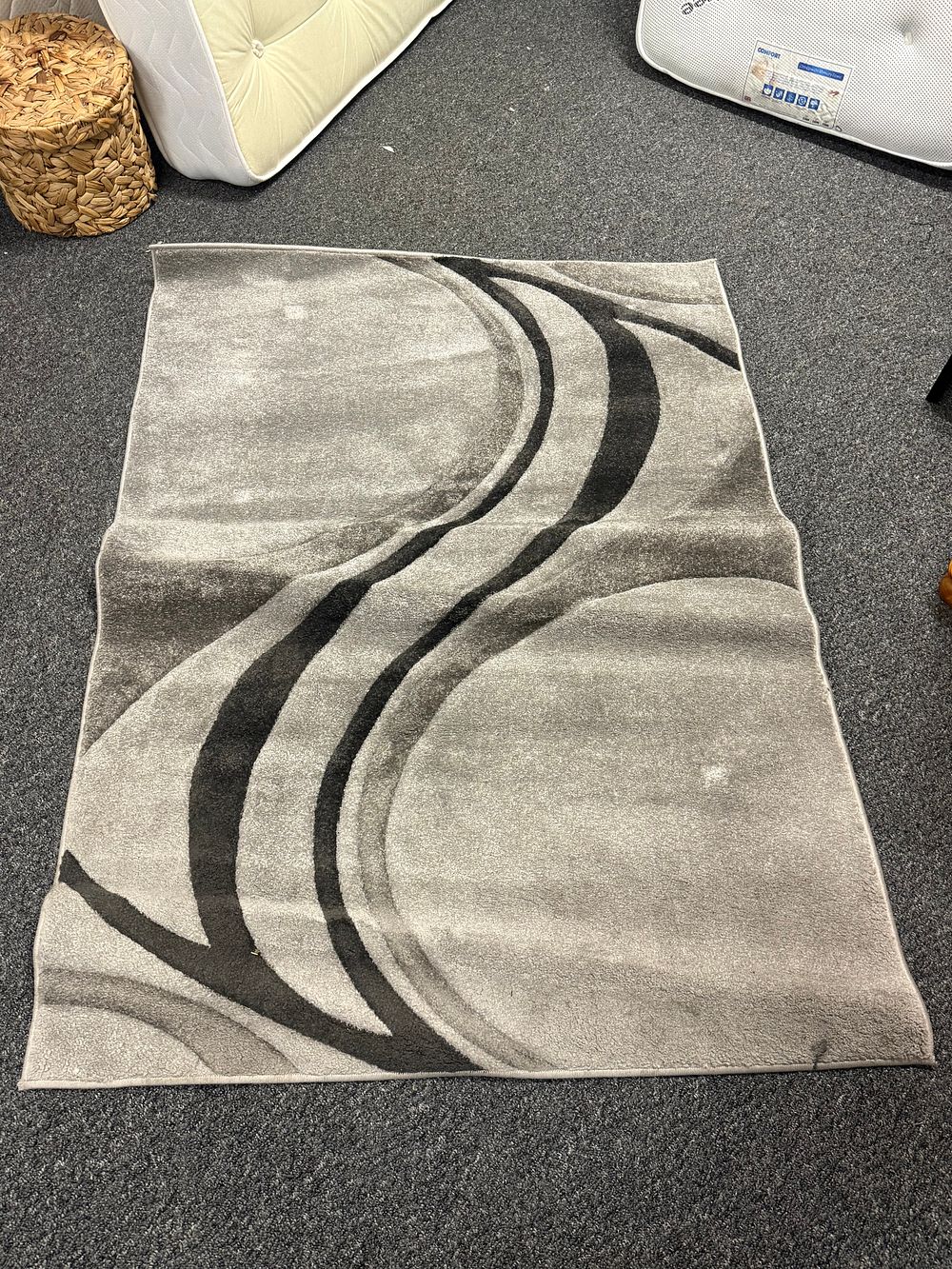 Lot 4: A Dunelm Mirage charcoal pattern area rug