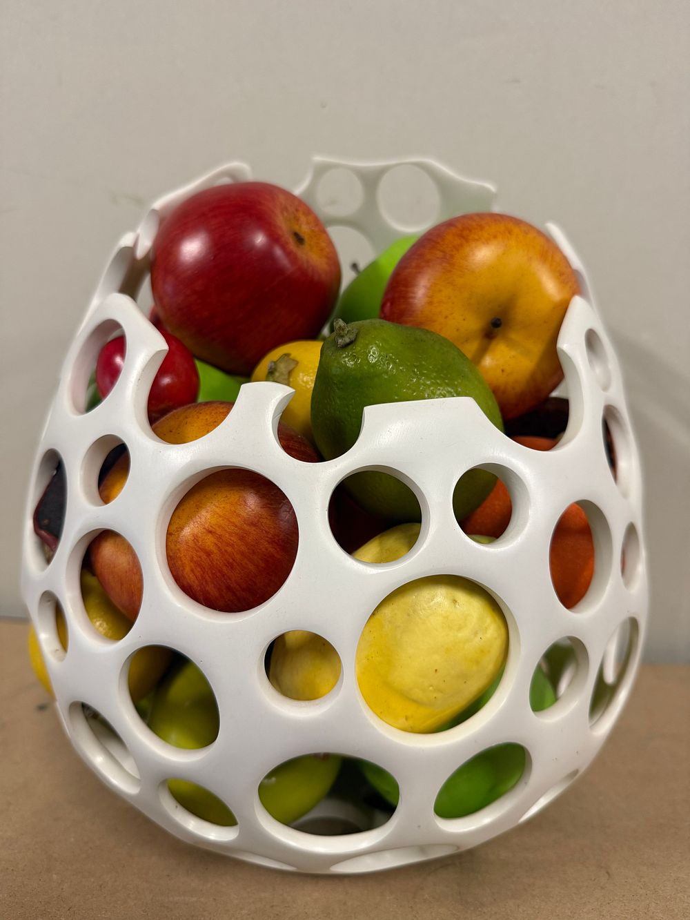 Lot 8: A white openwork bowl containing assorted artificial fruit