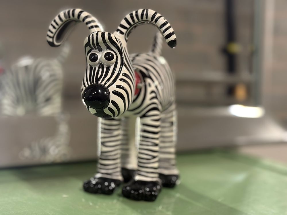 Lot 18: A Gromit Unleashed Grant's Gromit zebra-stripe ceramic figurine