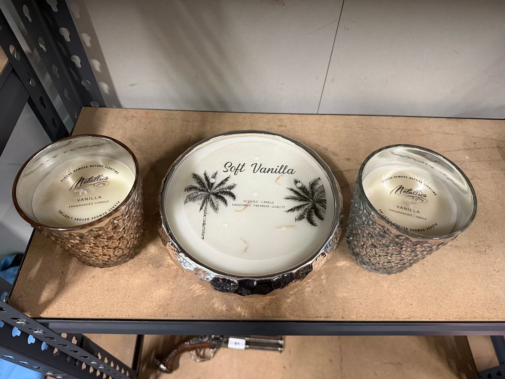 Lot 21: A trio of unused vanilla scented candles in metallic containers