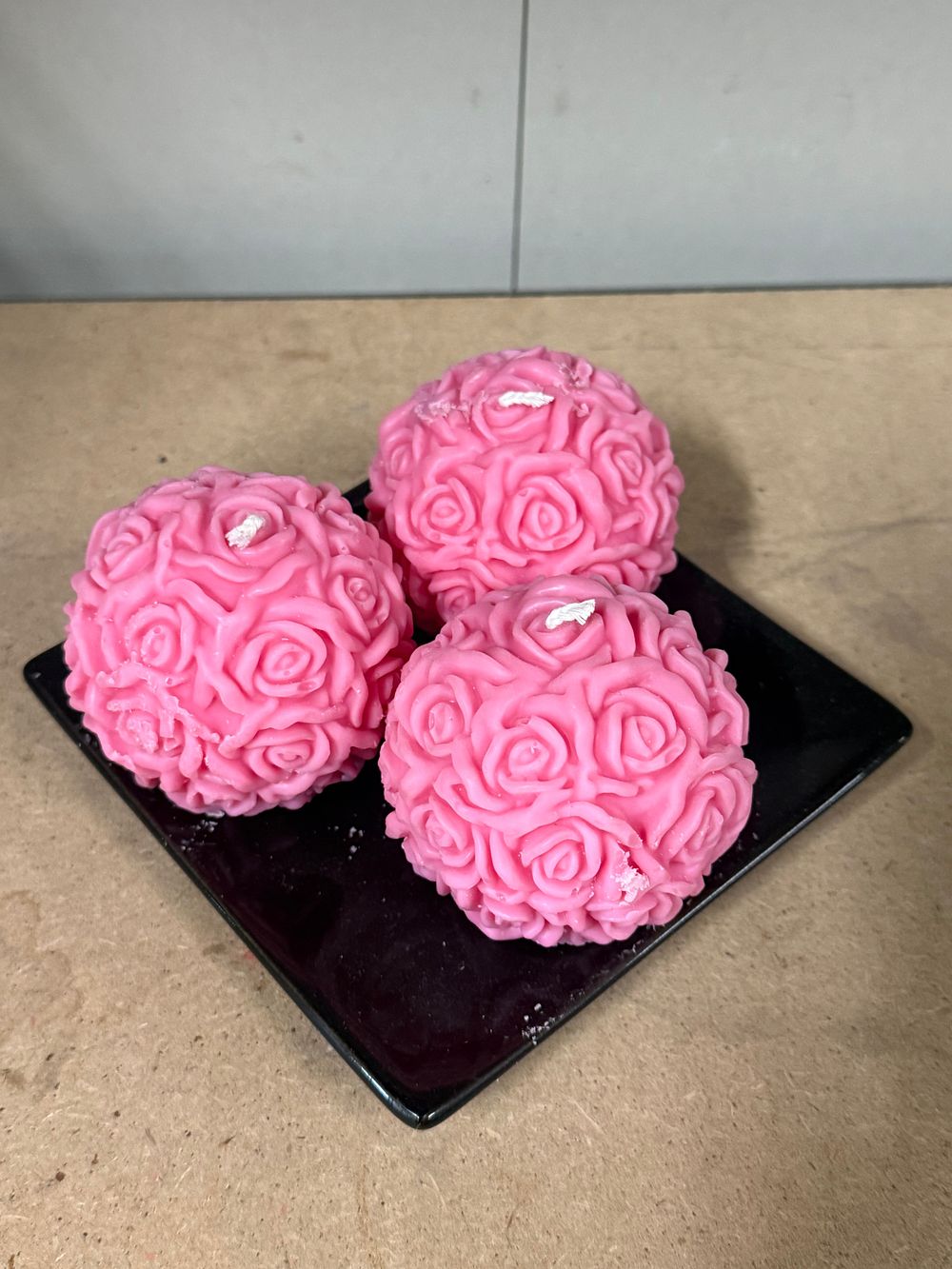 Lot 25: A trio of pink rose ball shaped decorative candles