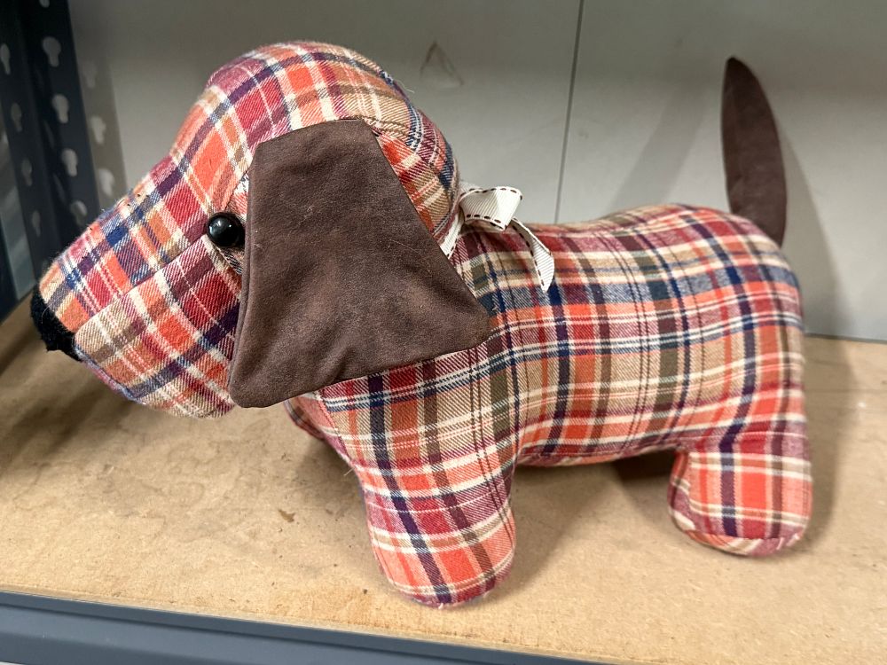 Lot 27: A weighted dog doorstop in multi-coloured plaid fabric