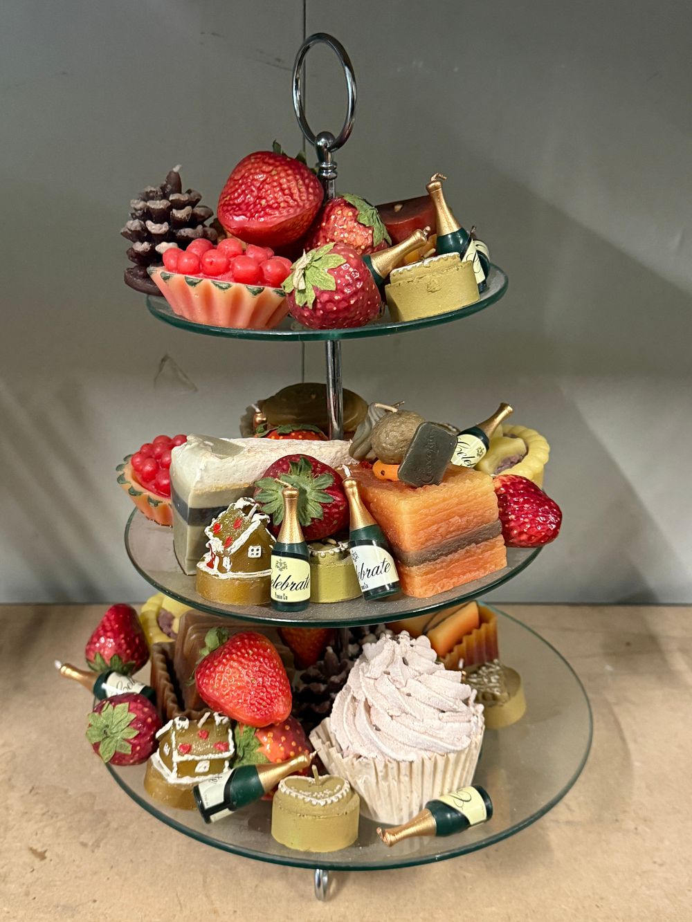 Lot 30: A collection of decorative novelty food and drink shaped candles on a glass cake stand