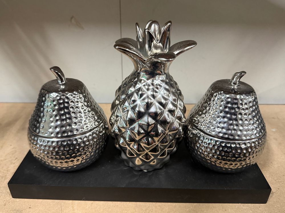 Lot 32: A trio of silver-toned fruit form candle holders
