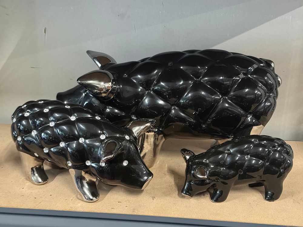 Lot 37: A trio of black and silver glazed piggy figurines
