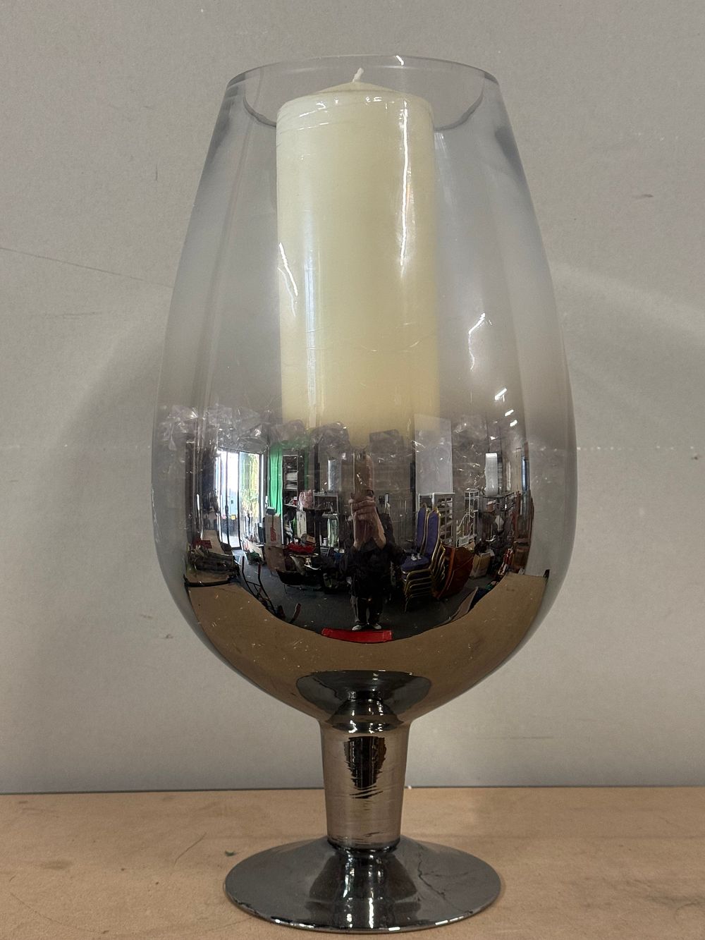 Lot 43: A large stemmed glass candle holder with silvered finish