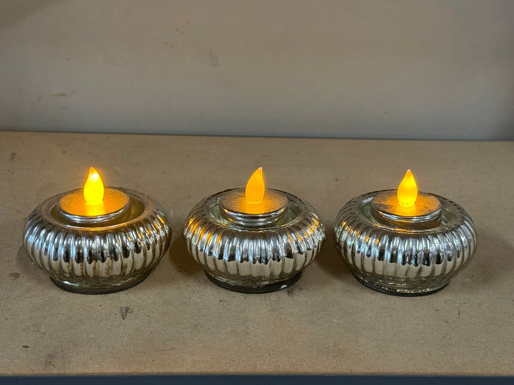 Lot 49: A trio of mercury glass holders with LED tealights