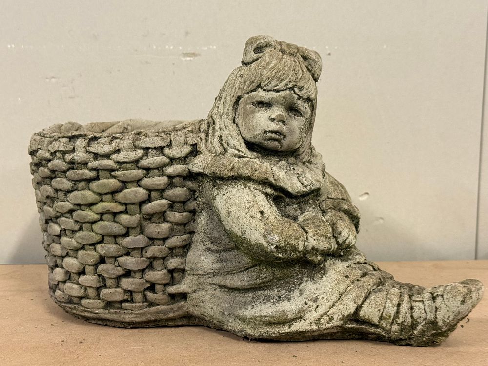 Lot 53: A cast stone garden planter of a seated girl beside a basket