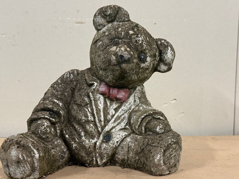 Lot 55: A weathered cast stone seated teddy bear garden ornament