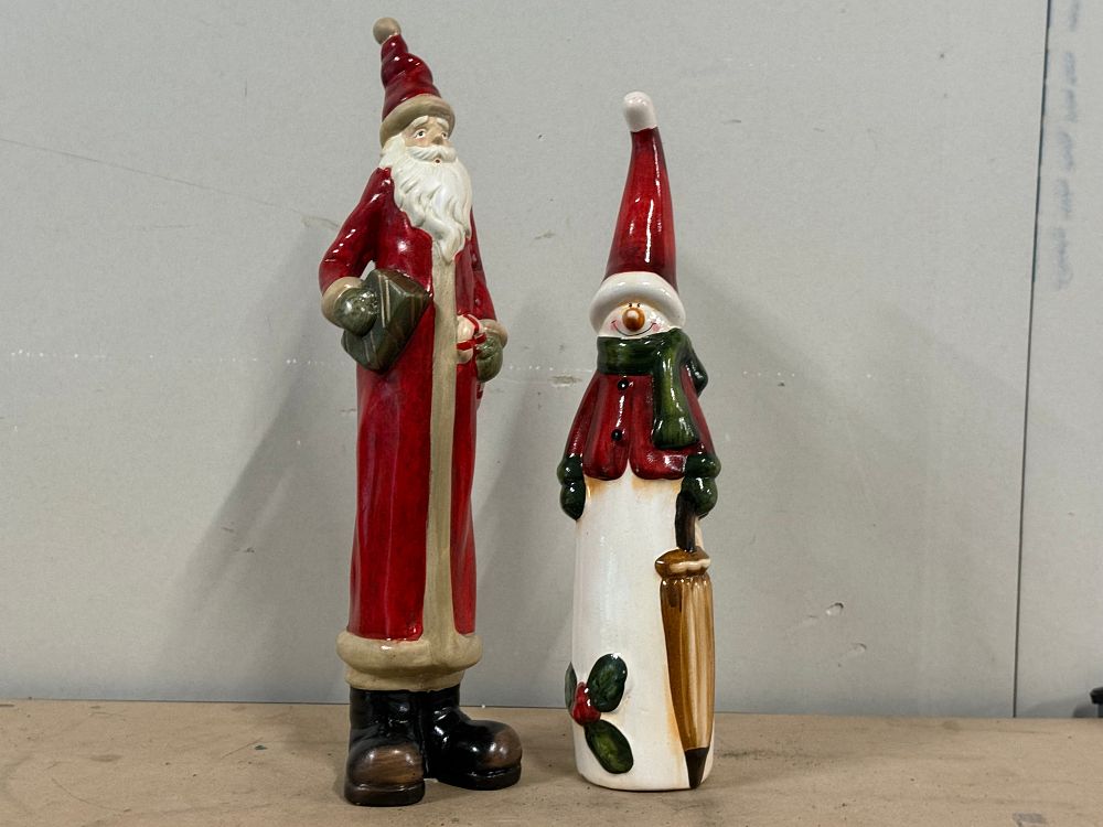 Lot 56: A pair of tall hand-painted glazed ceramic Christmas figurines